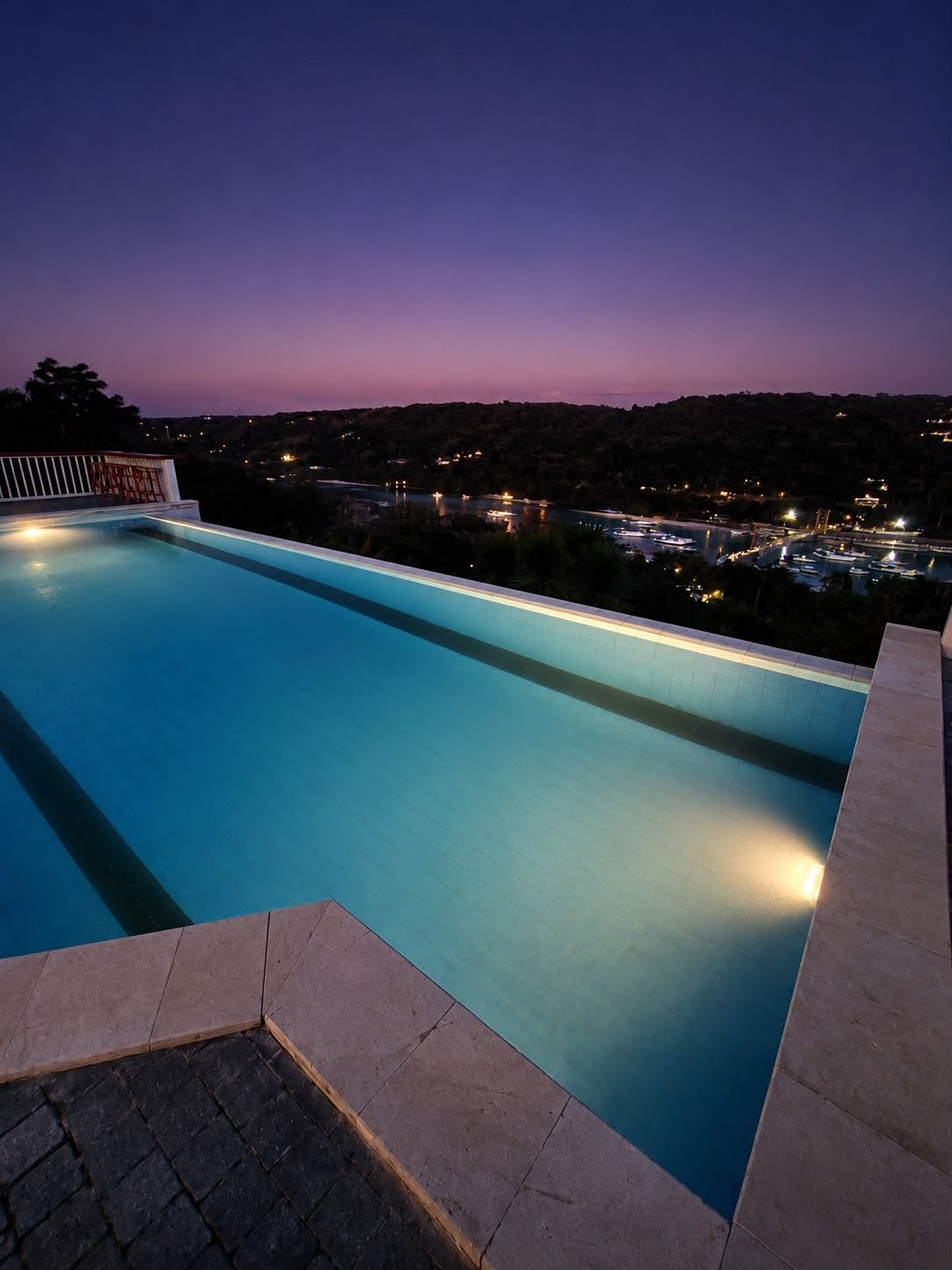 Infinity swimming pool overlooking to yellow bridge nusa lembongan and nusa ceningan