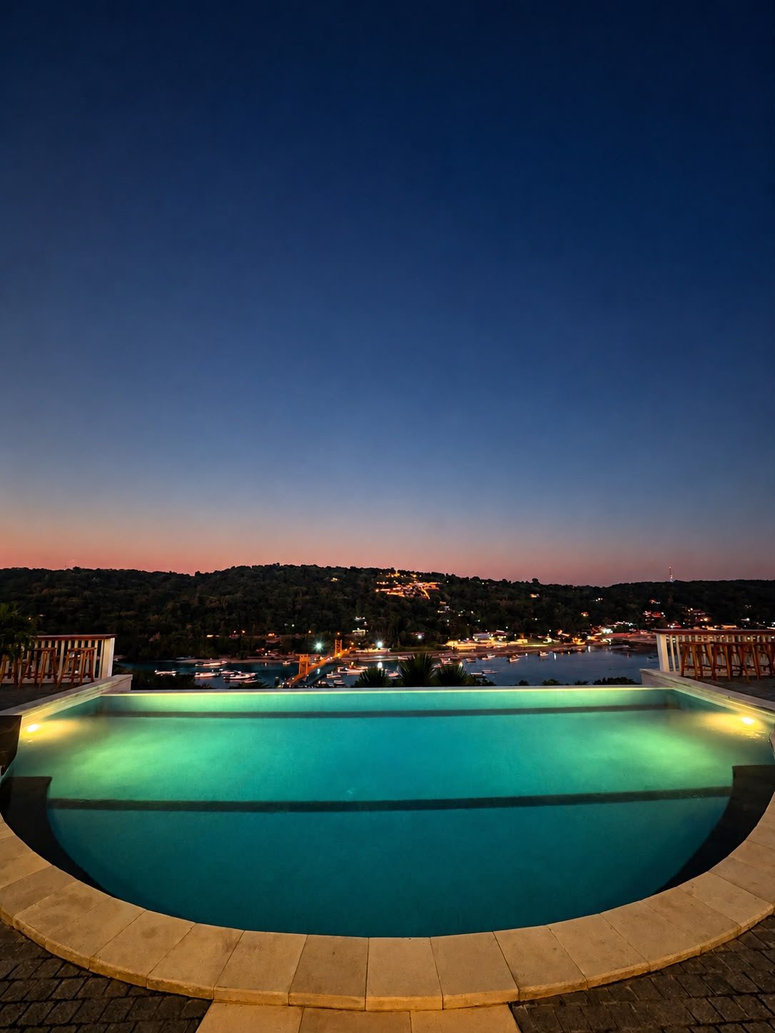 Infinity swimming pool overlooking to yellow bridge nusa lembongan and nusa ceningan
